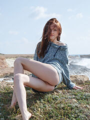 Redheaded Alice May exposes her elegant body at the beach