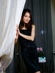 Anna Aki poses her black dress exposing her graceful body
