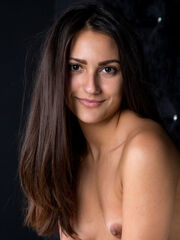 With a flirting smile on her divine face, Cira Nerri smoothly bound her nude body and amazing assets