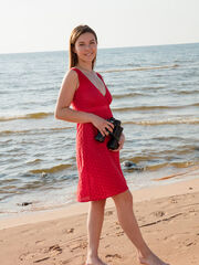 Dominika Jule provocativly poses by the sandy beach as she strips her sexy, svelte body