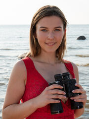 Dominika Jule provocativly poses by the sandy beach as she strips her sexy, svelte body