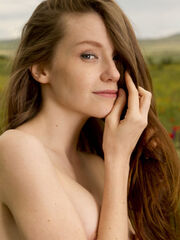 Emily Bloom's pretty smile and young body sticks out in a field of blossoms
