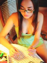 Li Moon showcases her nerdy glasses as she unsheathes her breathtaking body