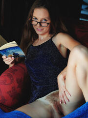 Geeky Sofi Shane flaunts off her hairy muff while reading on the couch
