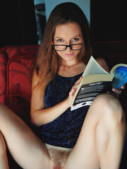 Geeky Sofi Shane flaunts off her hairy muff while reading on the couch