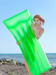 Violla A playing with inflatable mattress absolutely nude on the beach