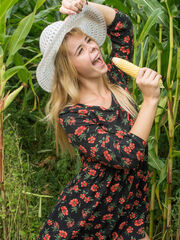 Yelena gaily poses in the corn field having fun with her swollen pussy